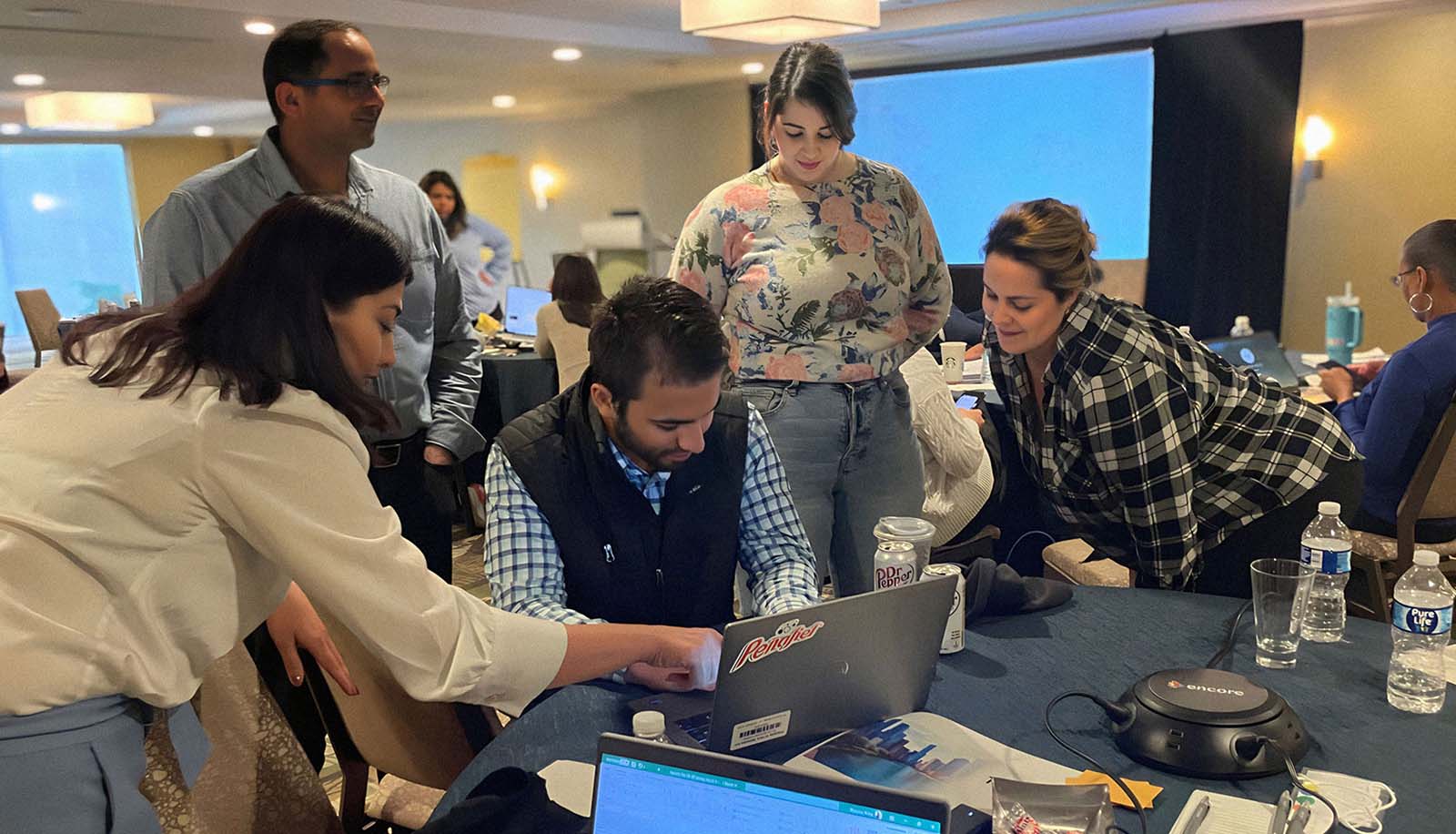 Employees working on a presentation with Center of Gravity